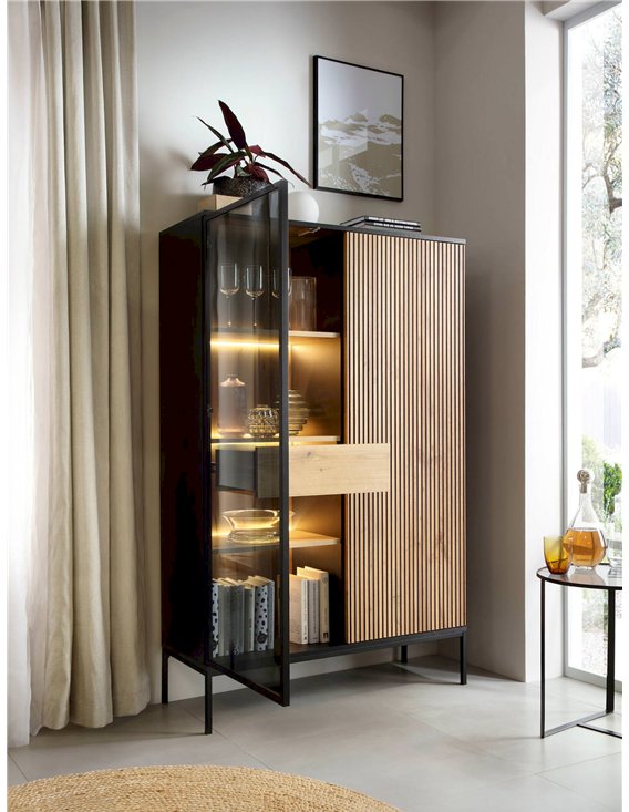 Vitrine haute noire et bois clair ouverte, avec livres et tiroir central