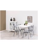 Quatre chaises grises autour d'une table blanche dans une pièce épurée