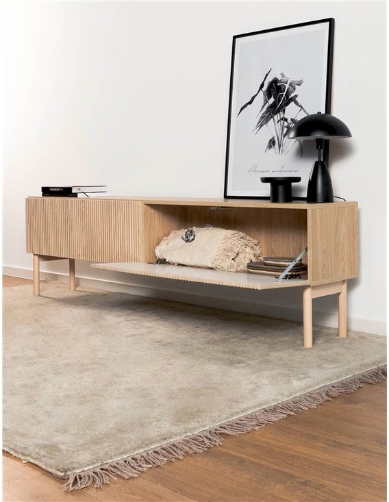 Meuble TV japandi en bois clair posé sur tapis beige avec cadre et lampe