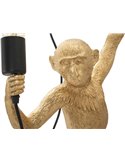 Singe doré sculptural tenant une lampe