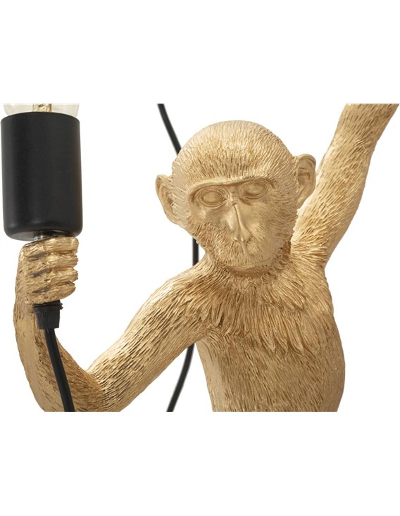 Singe doré sculptural tenant une lampe