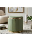 Pouf vert en ambiance de salon, posé sur un tapis, avec livres et plante verte