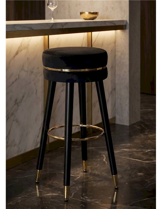 Tabouret de bar rond noir à cerclage doré vu de face sur fond blanc