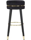 Tabouret de bar rond noir en mise en situation devant un comptoir en marbre