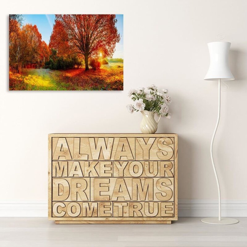 Tableau paysage d'automne suspendu au-dessus d'un meuble bas décoratif