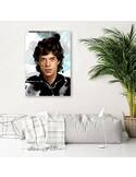 Tableau portrait de Mike Jagger accroché au-dessus d'un canapé clair et d'un plant