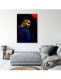 Tableau portrait de footballeur de profil au-dessus d'un canapé gris et d'un pouf