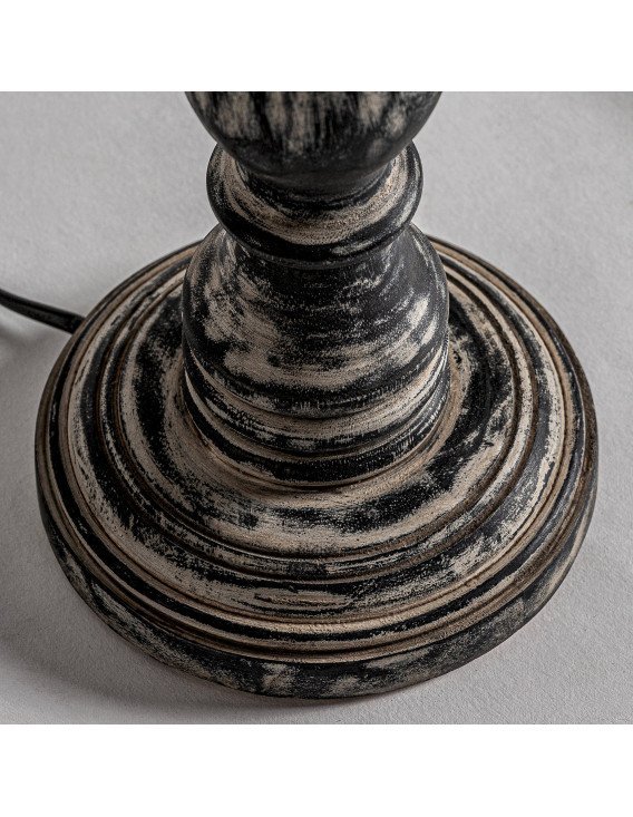 Détail du pied gris patiné avec ses moulures circulaires et le câble noir